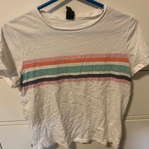 White t-shirt with colored stripes.